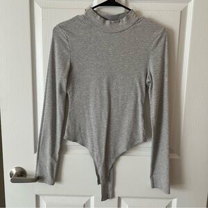 Kittenish grey smock neck bodysuit